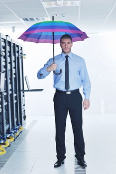 businessman hold umbrella in server room photo