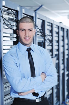 young it engineer in datacenter server room photo