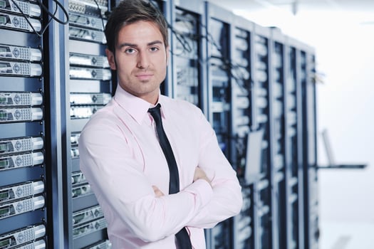 young it engeneer in datacenter server room photo