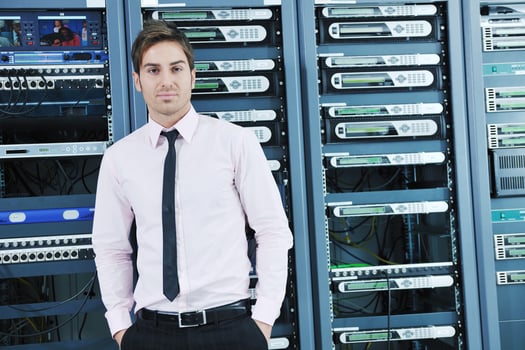 young it engineer in datacenter server room photo
