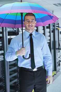businessman hold umbrella in server room photo