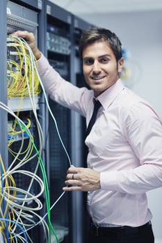 young it engeneer in datacenter server room photo