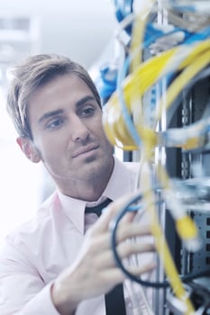young it engeneer in datacenter server room photo