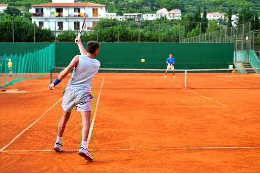 Man plays tennis outdoors photo