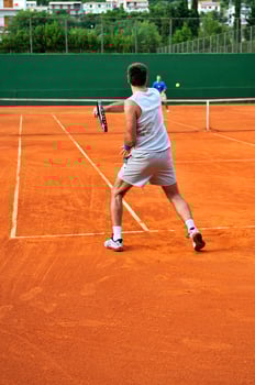 Man plays tennis outdoors photo