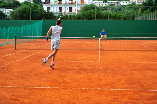 Man plays tennis outdoors photo