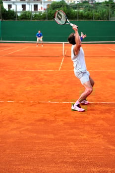 Man plays tennis outdoors photo
