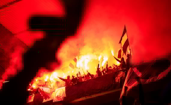 football hooligans with mask holding torches in fire photo