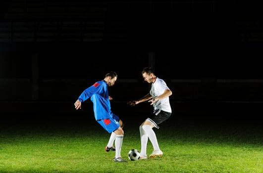 football players in action for the ball photo