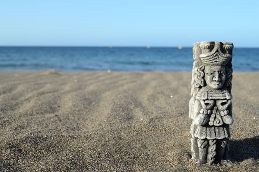 Ancient Maya Statue on the Sand Beach photo