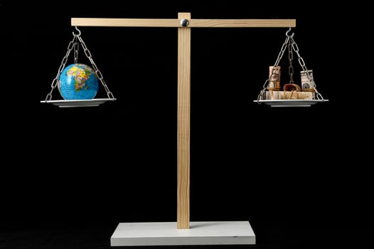 Earth and Money on a Two Pan Balance photo