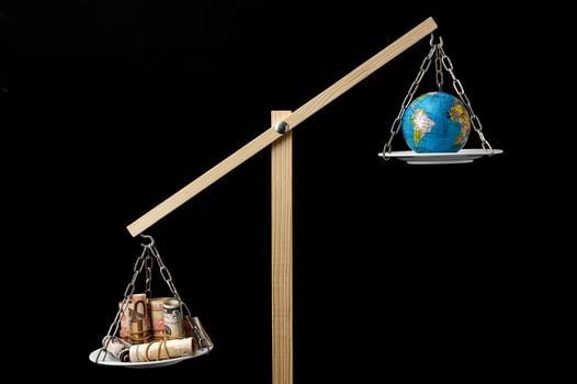 Earth and Money on a Two Pan Balance photo