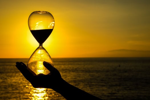 Hand holding hourglass photo