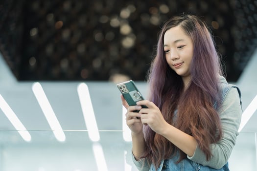 Woman use of cellphone at department store photo