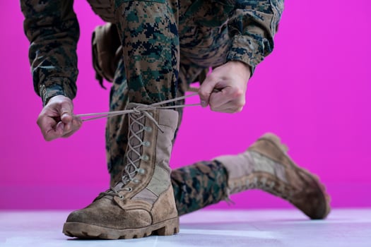 soldier tying the laces on his boots photo