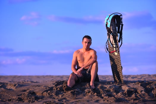 Portrait of a young  kitsurf  man at beach on sunset photo