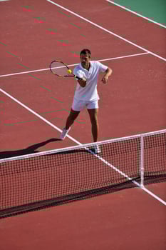 young man play tennis outdoor photo