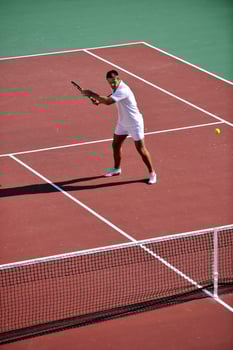 young woman play tennis outdoor photo