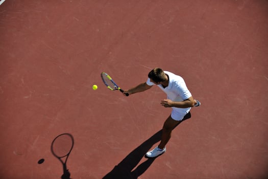 young man play tennis outdoor photo