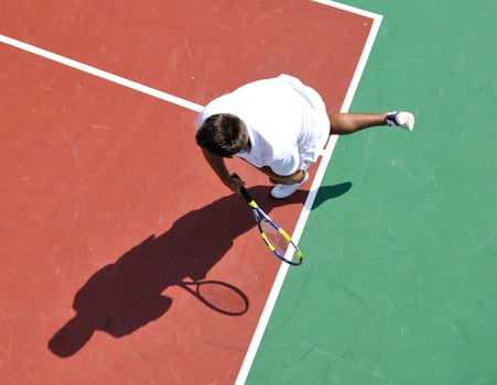 young man play tennis outdoor photo