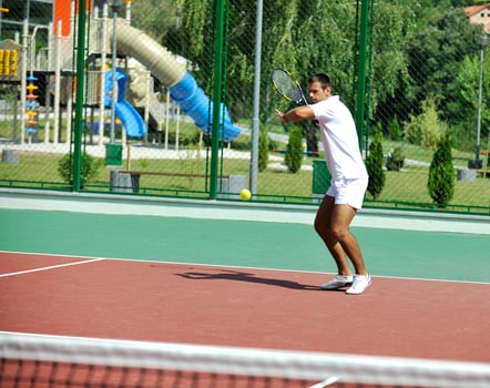 young man play tennis outdoor photo