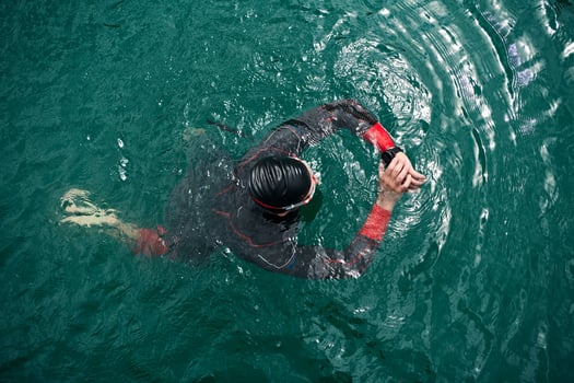 triathlon athlete swimming on lake setting smartwatch photo
