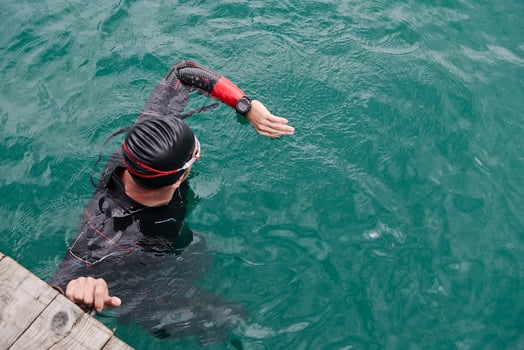 triathlon athlete swimming on lake setting smartwatch photo