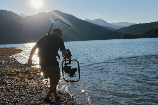 videographer  taking action shot of triathlon swimming athlete photo