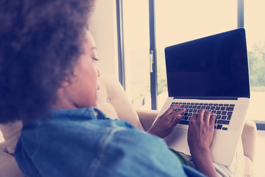 African American women at home in the chair using a laptop photo