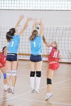 girls playing volleyball indoor game photo