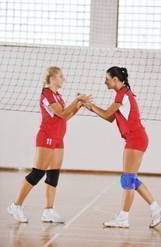 girls playing volleyball indoor game photo