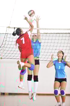 girls playing volleyball indoor game photo
