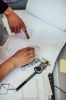 Engineer technician designing drawings mechanical parts engineering Enginemanufacturing factory Industry Industrial work project blueprints measuring bearings caliper tools photo