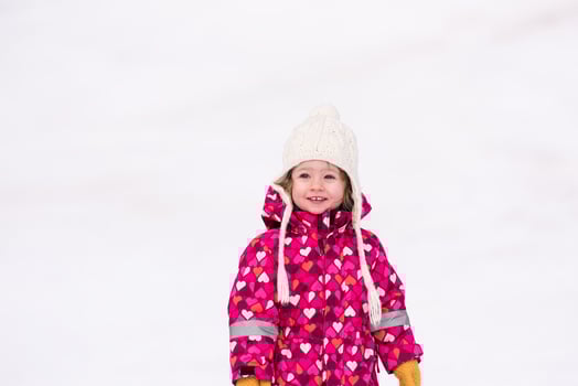 little girl having fun at snowy winter day photo