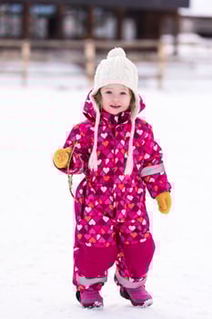 little girl having fun at snowy winter day photo