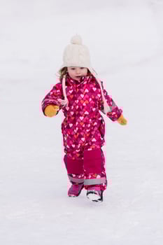 little girl having fun at snowy winter day photo