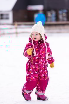 little girl having fun at snowy winter day photo