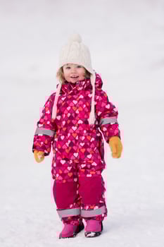 little girl having fun at snowy winter day photo