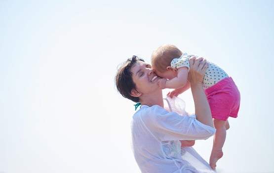 mom and baby on beach  have fun photo