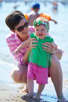 mom and baby on beach  have fun photo