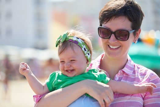 mom and baby on beach  have fun photo