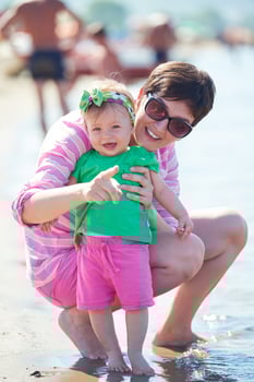 mom and baby on beach  have fun photo