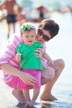mom and baby on beach  have fun photo