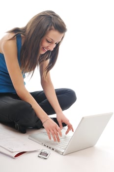one young girl work on laptop isolated on white photo