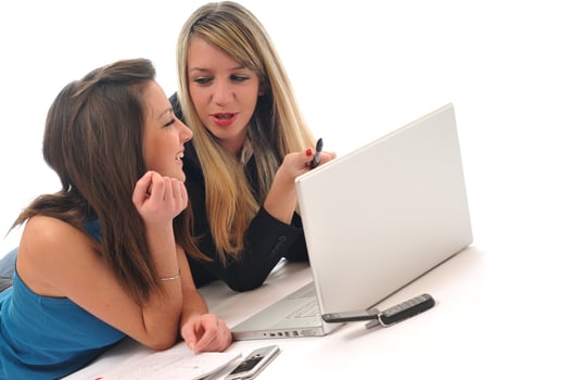 two young girls work on laptop isolated photo