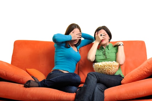 female friends eating popcorn and watching tv at home photo