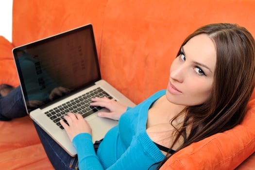woman using a laptop computer at home photo