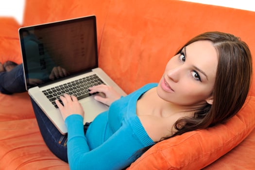 woman using a laptop computer at home photo