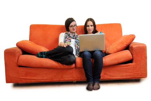 female friends working on laptop computer at home photo