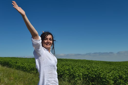 Young happy woman in green field photo